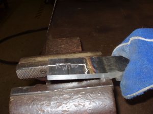 Weld test backing bar removal.