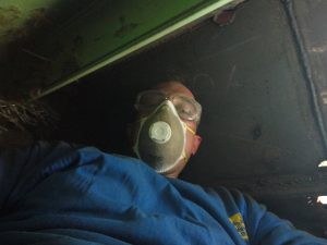 Confined space with bad air quality wearing a dirty respirator.