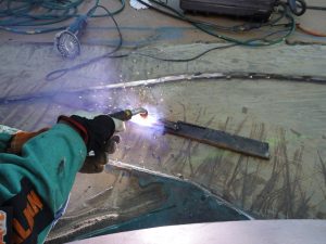 Setting up the Fluxed Cored Arc Welder and dialing it in for our material thickness.