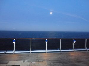 Moon over top deck of Carnival Spirit.