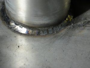 Cleaned stainless steel pipe to plate fillet weld using a SMAW/Stick E308 electrode.