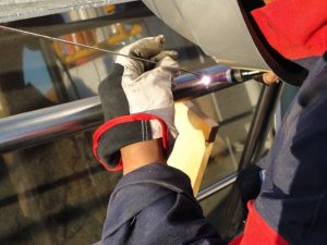 TIG welding stainless steel handrails.